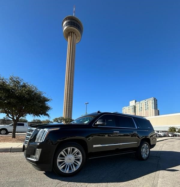 Cadillac Escalade Platinum ESV parked in front of the San Antonio Tower of the Americas